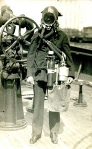 Lieutenant John Williams wearing a diver's mask and breathing apparatus, circa 1915.